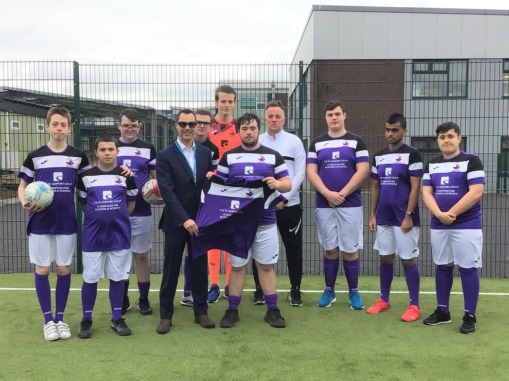 Phil Bird of The PC Support Group presents the Rumworth School football team with their new kit-2